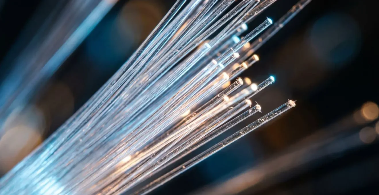 Macro close-up of fiber optic cables with light transmission representing low-latency data transfer