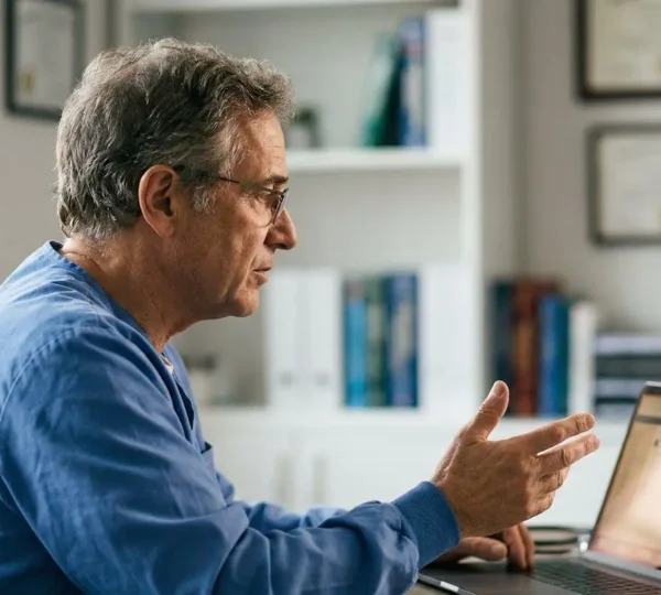 A healthcare professional conducting a virtual medical consultation via video call, emphasizing the technological divide between remote and in-person care